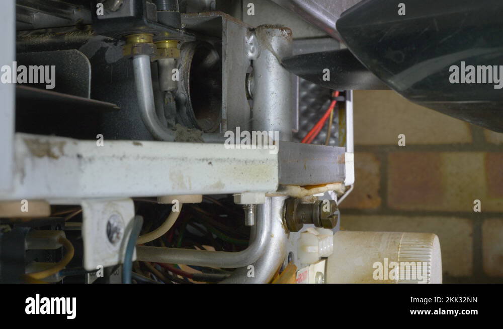 Small vacuum cleaner cleaning the inside of an old central heating boiler Stock Video Footage