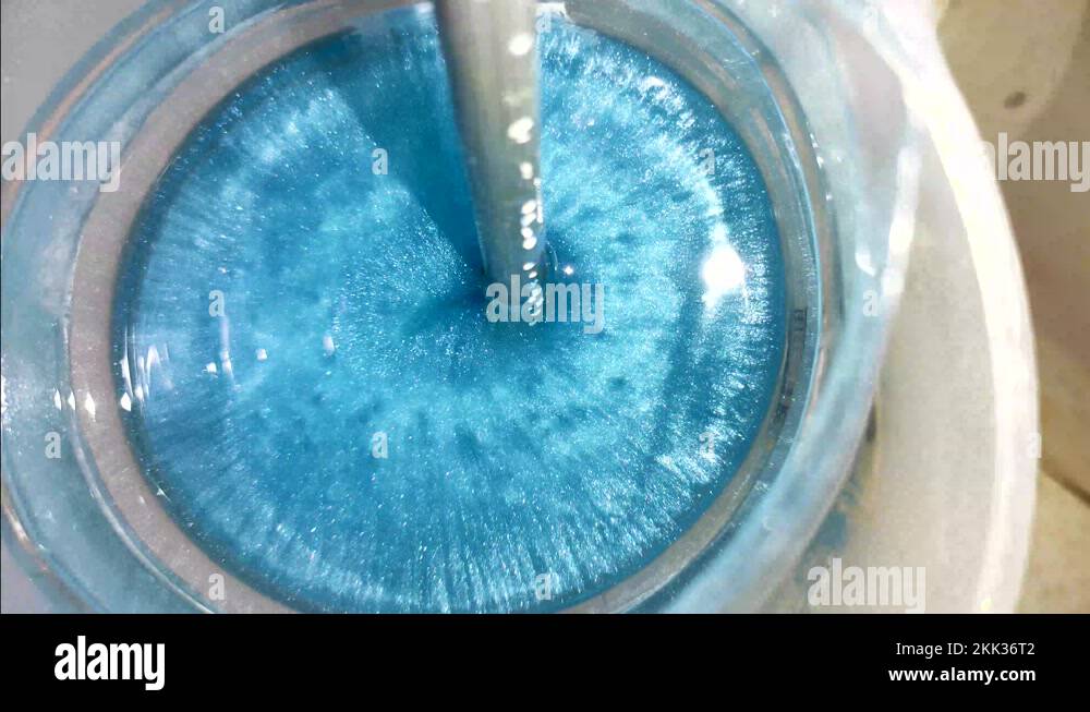 Mixing epoxy resin with blue pigment. Epoxy bubbles are evaporates at