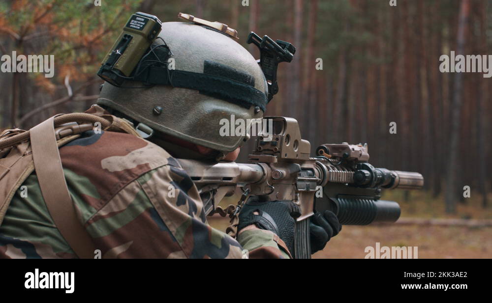 A soldier in a special military uniform, with a helmet on his head and ...