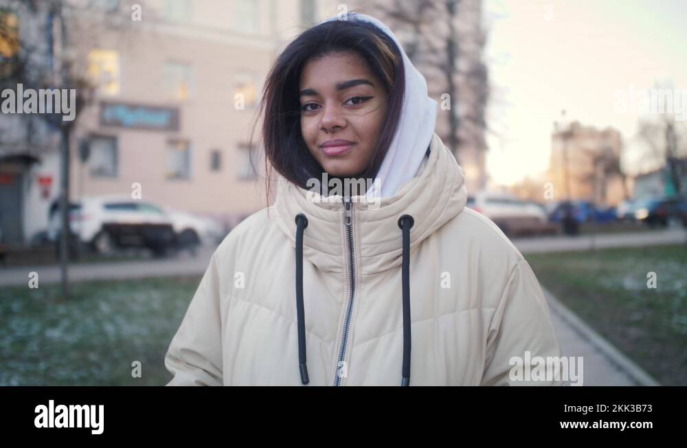 Hipster gen z teen girl smiling face with nose piercing looking at
