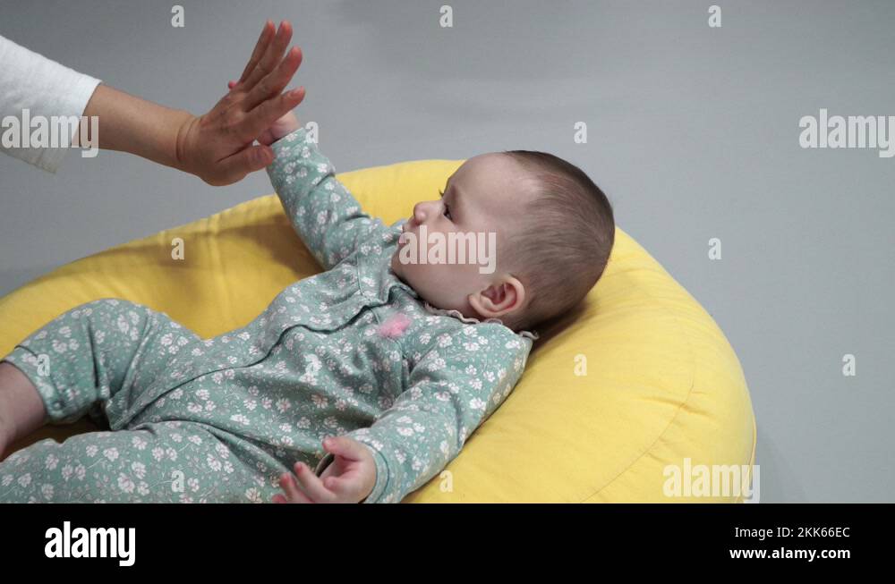 Cute Baby Girl Plays With Her Mother By Tapping Her Hand Interacting