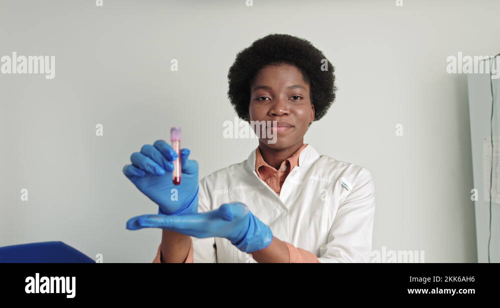 Female african scientist doctor doing blood test in laboratory. Covid