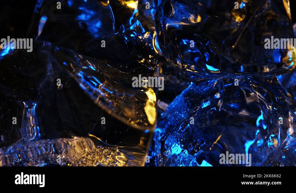 Ice cubes rotate on an axis. 4K color yellow and blue wallpaper Stock ...