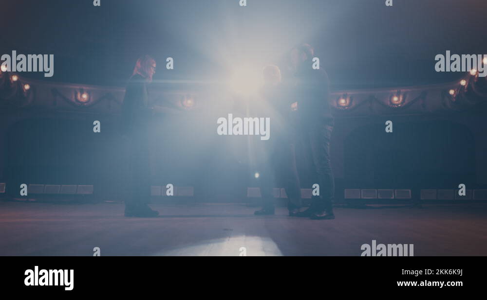 Director giving instructions to actors in spotlight Stock Video Footage