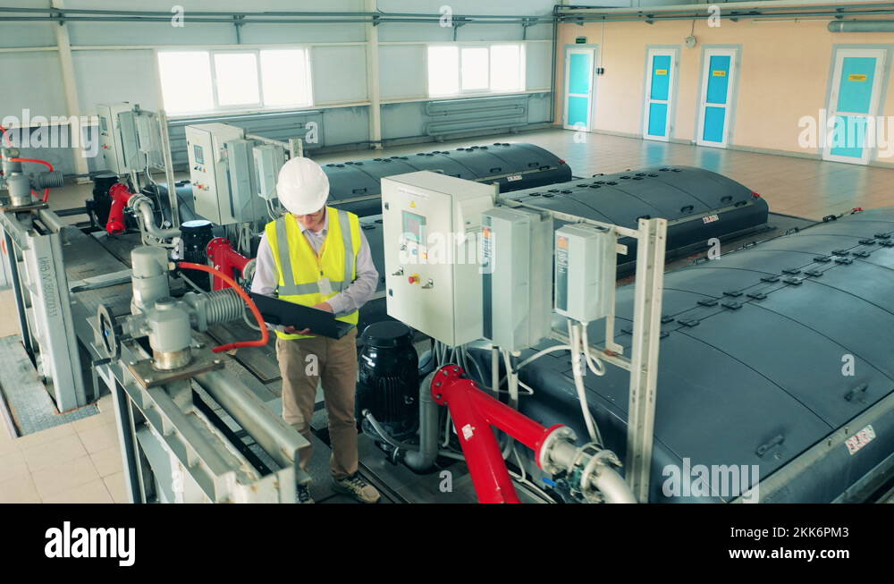Wastewater treatment operator inspecting a water cleaning system using