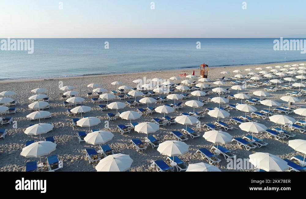 Bathhouse in summer. Beach equipped with umbrellas, deck chairs and sun