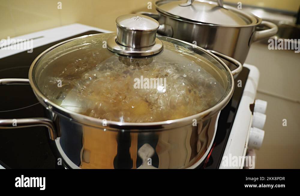 Pot with glass lid where you can see boiling water Stock Video Footage