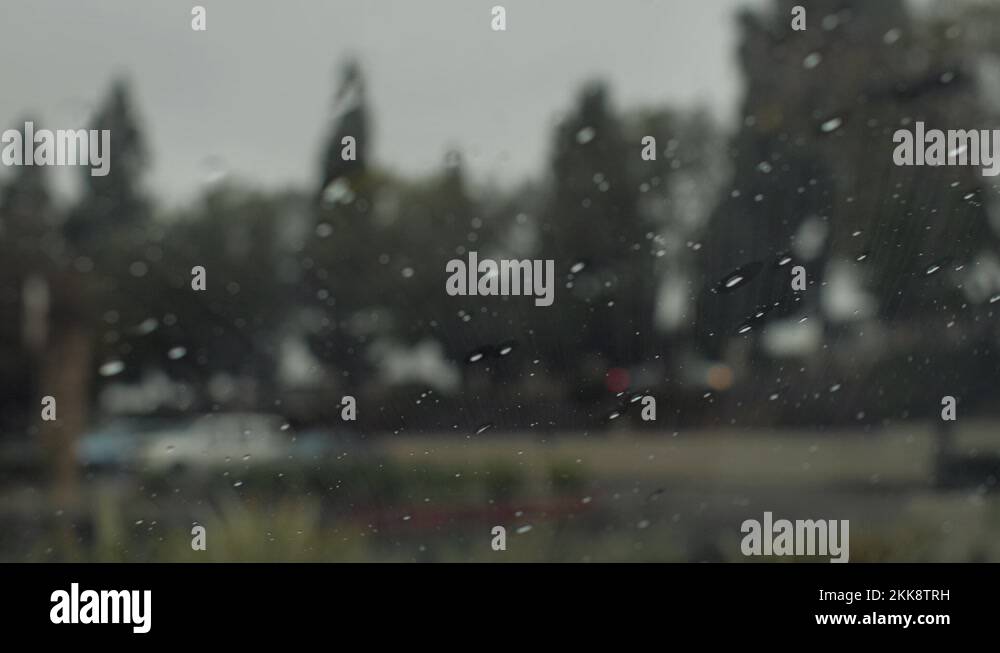 Windshield Wipers Slowly Wiping Rain Drops Off Of A Car POV Inside Of