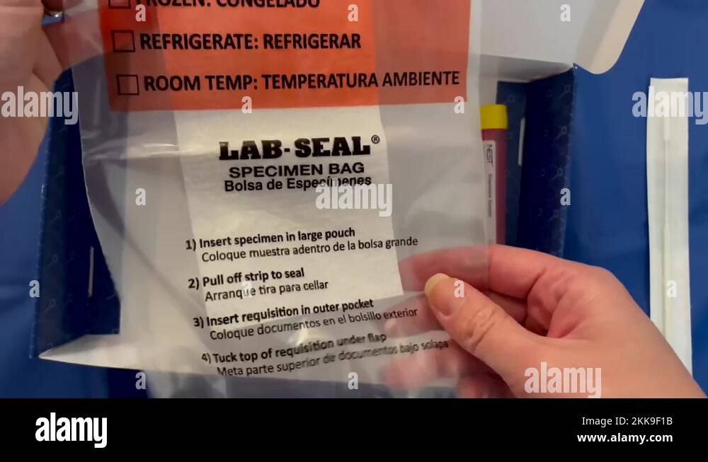 Hand holding a LAB SEAL Specimen Bag for COVID19 (SARSCoV2) IN HOME