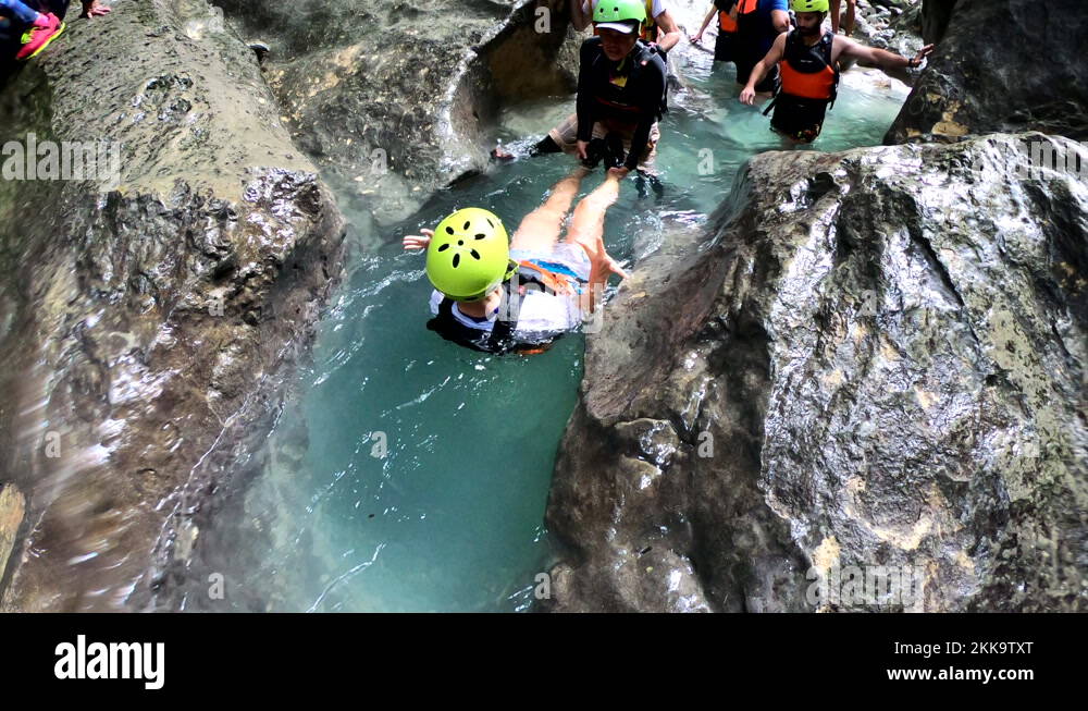 Woman slides into Kawasan falls in Philippines. Top view Stock Video