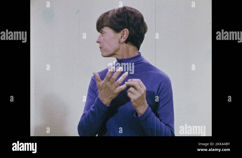 1960s woman holds up hands, girl puts hands around woman's neck, woman