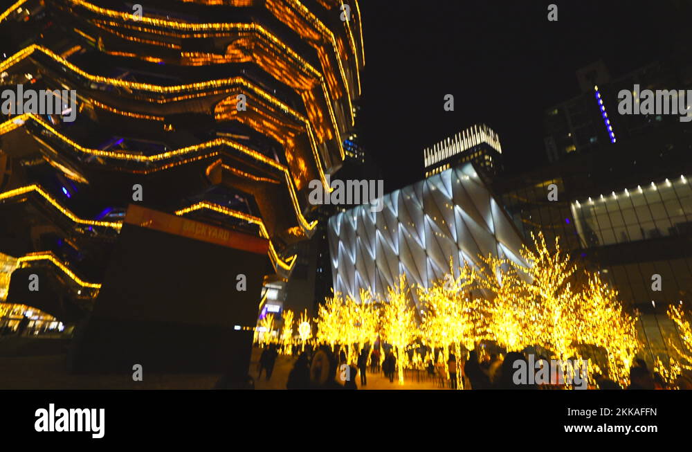 Many illuminated trees surround the Vessel by Christmas lights at