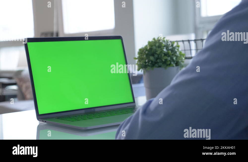 Close-up of male hands using green screen chroma key laptop typing ...