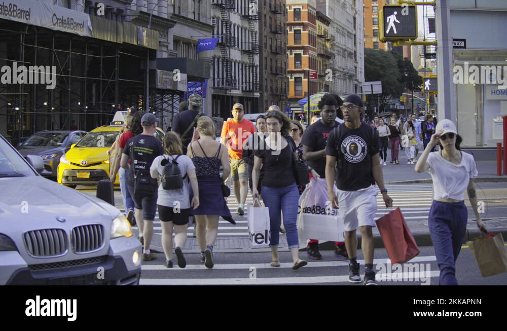 New York City busy street traffic lights zebra crossing people walk