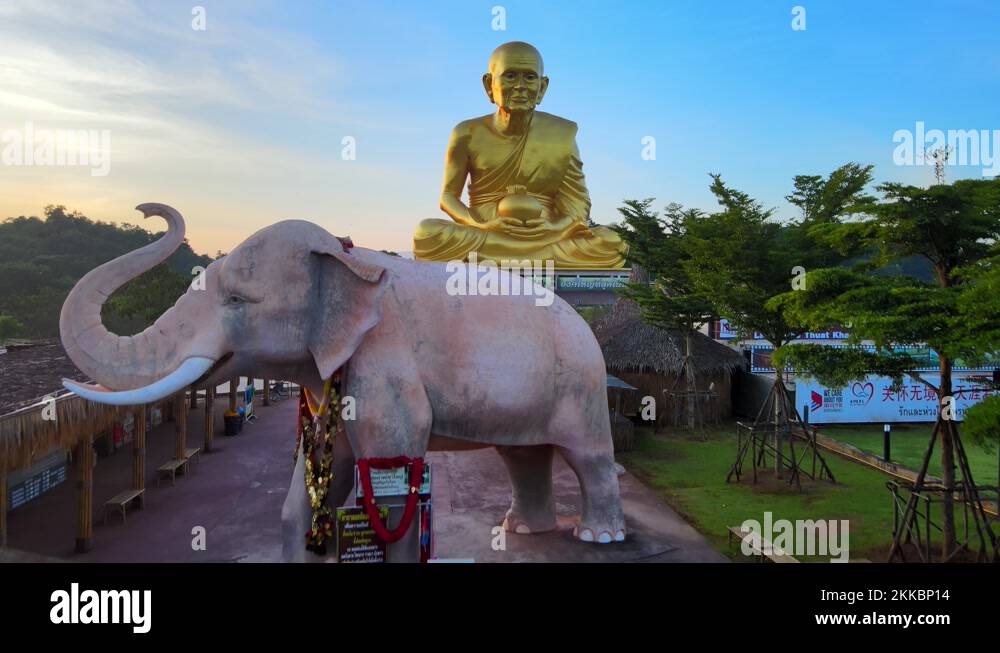 4k drone flies above an Elephant statue to The biggest golden statue of