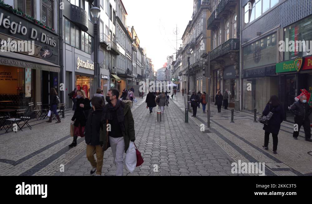 People wear face mask and shop in the main pedestrian street in