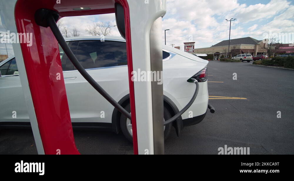 Tesla Electric Car, Supercharger Charging Station. Car Charging Stock