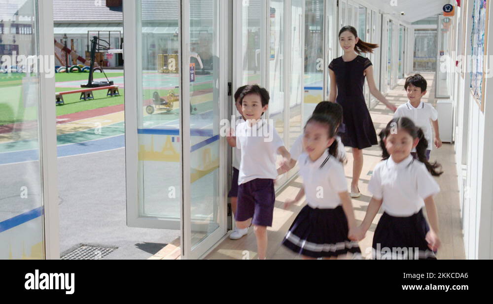 Chinese teacher and children in school hallway,4K Stock Video Footage ...