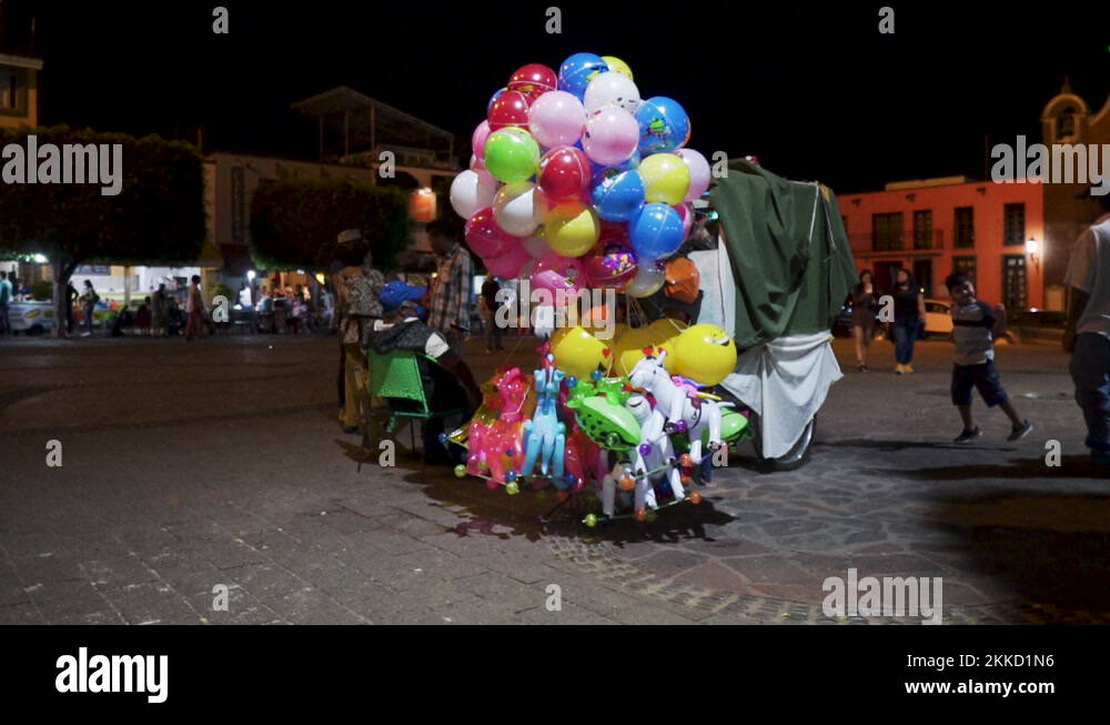 Ballon Vendor on public town square at night in Tequila Town in Jalisco