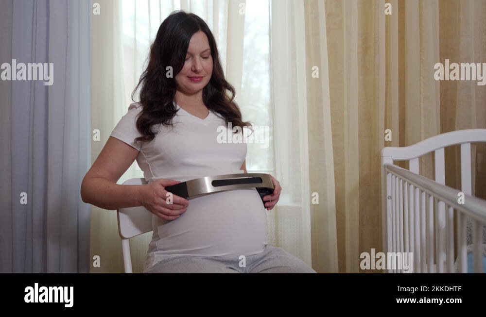pregnant woman giving music to listen to her unborn baby during ...
