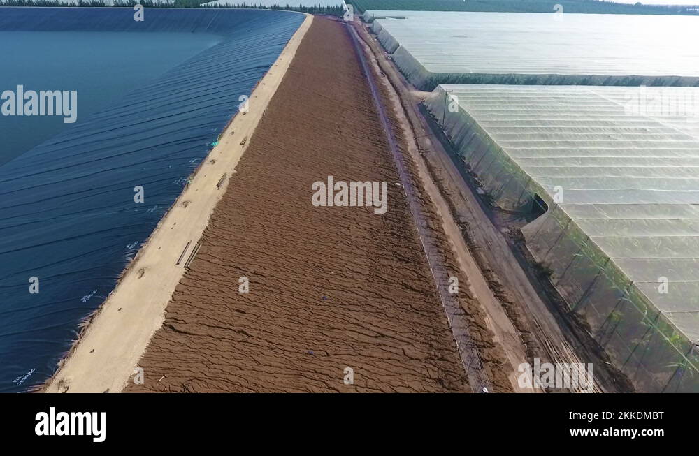 Aerial tilt down to show the side of a solar collection array and the ...