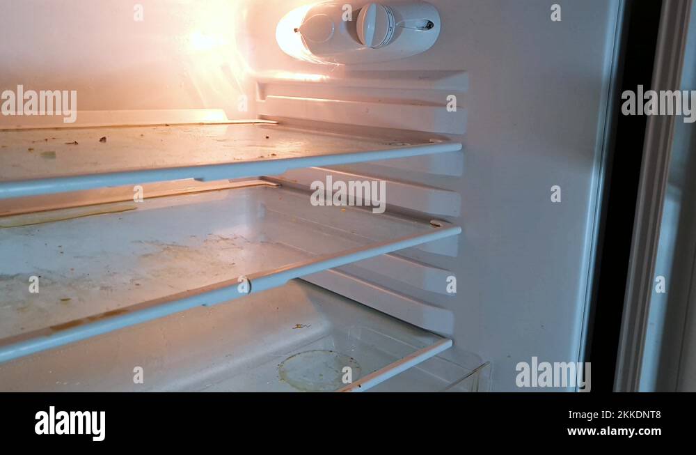Overview pan down of an very dirty empty fridge Stock Video Footage Alamy