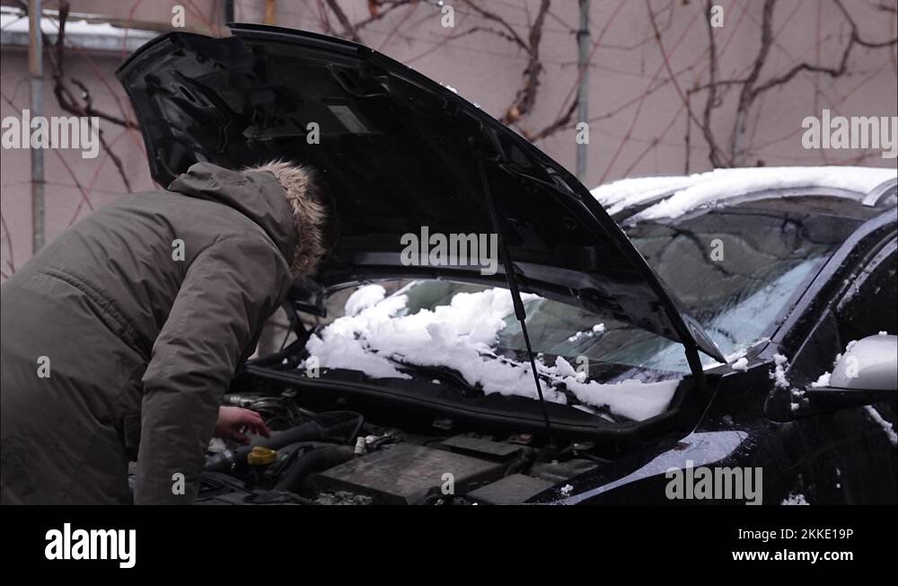 Man open hood of the car and trying to find out what is happened with