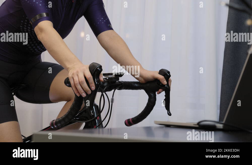 Changing gears on stationary bicycle. Hands are changing speed switch