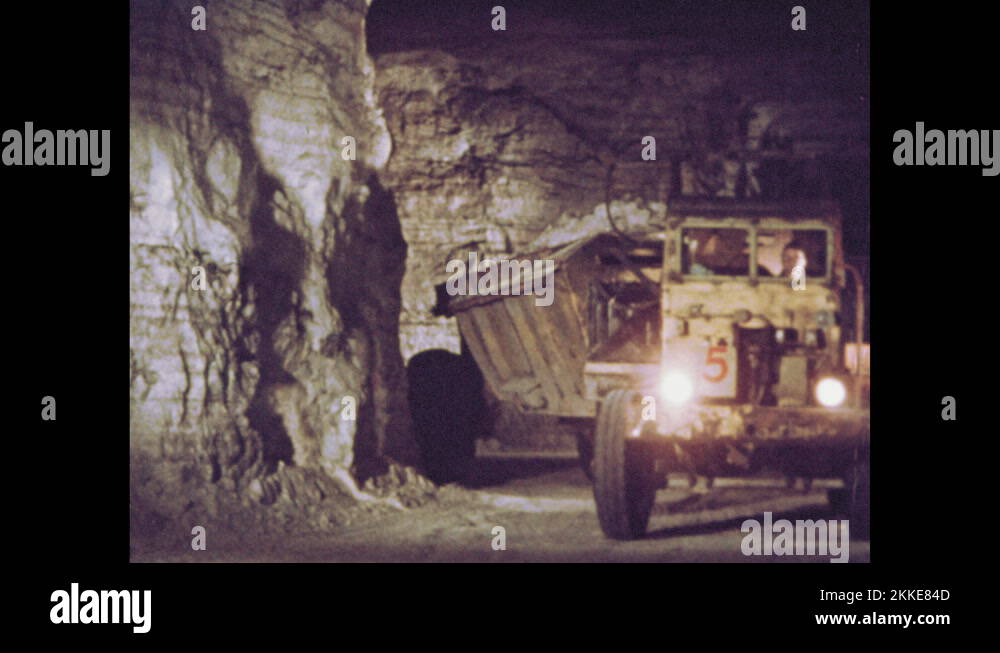1960s Underground salt mine tunnel with dump truck. Pile of salt at