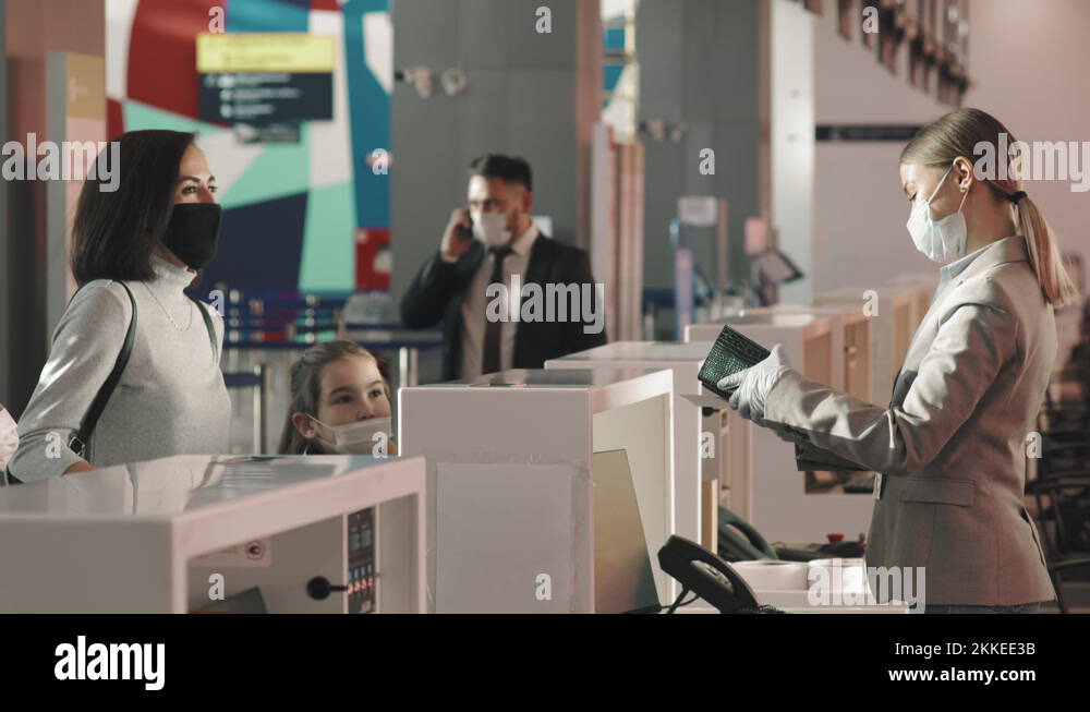 Mother With Kids At Check-In Counter Stock Video Footage - Alamy