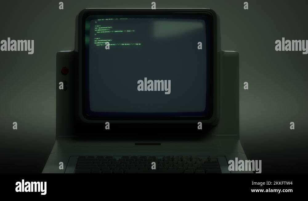 Retro personal computer or PC with source code displayed on monitor ...