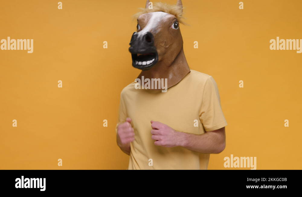 Funny Dances Happy Young Man in Horse Mask Rhythmically Moving his Arms
