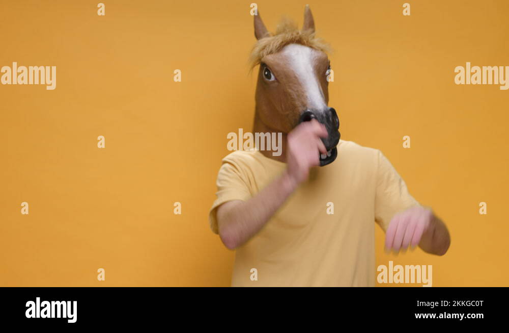 Funny Dances Happy Young Man in Horse Mask Rhythmically Moving his Arms