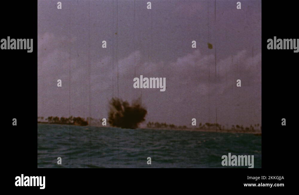 1940s: Long shot of ship, guns firing. Plane flying, explosion on ship ...