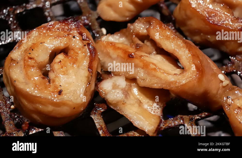 Motion of people cooking bbq pork intestine on table inside Chinese