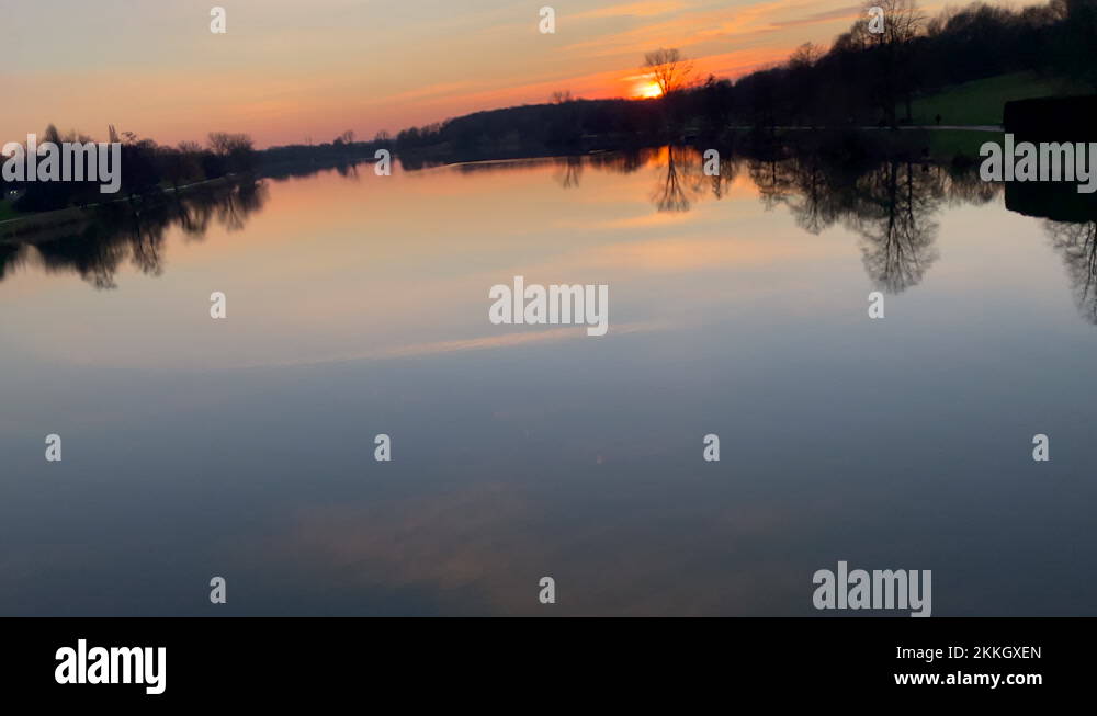 Pristine Lake With Sunset Sky Reflection On Water In Germany. - Tilt-Up ...