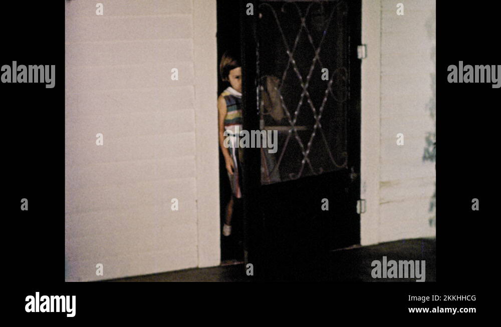 1950s White rabbit hops down tiny stairs. Little girl opens screen