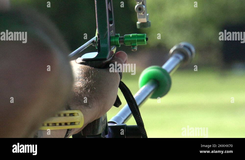 Aiming and shooting a recurve bow, archery target practice, close up