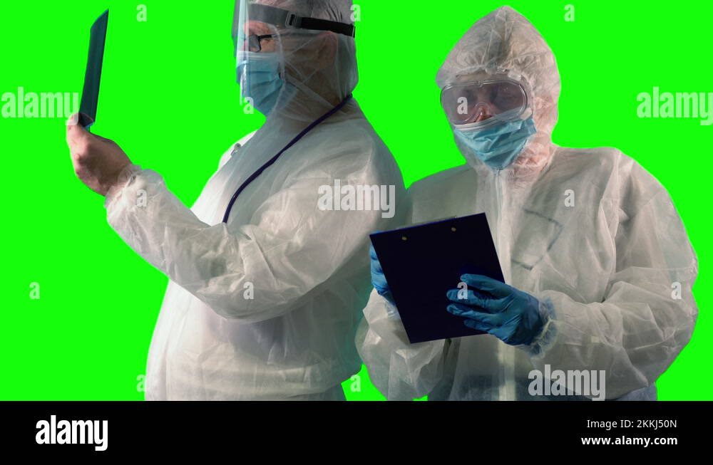 Doctor in PPE suit uniform with stethoscope is inspecting a patient's X