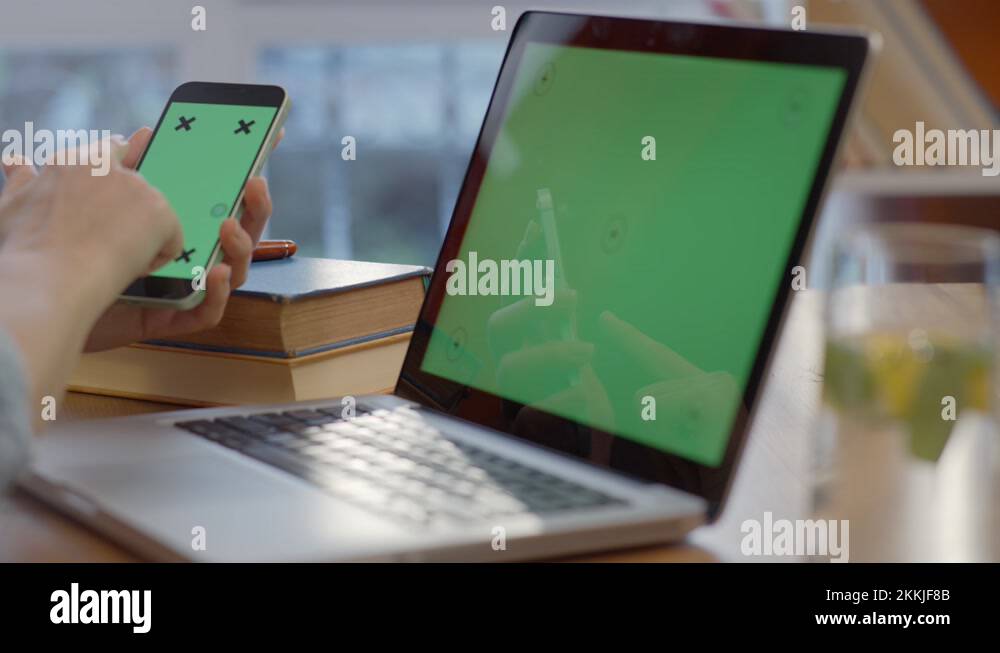 The woman's hand is working on the green screen computer Stock Video ...