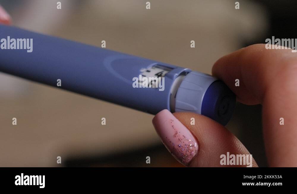 Diabetes patient turn knob on insulin pen and dial up insulin dose for injection Stock Video