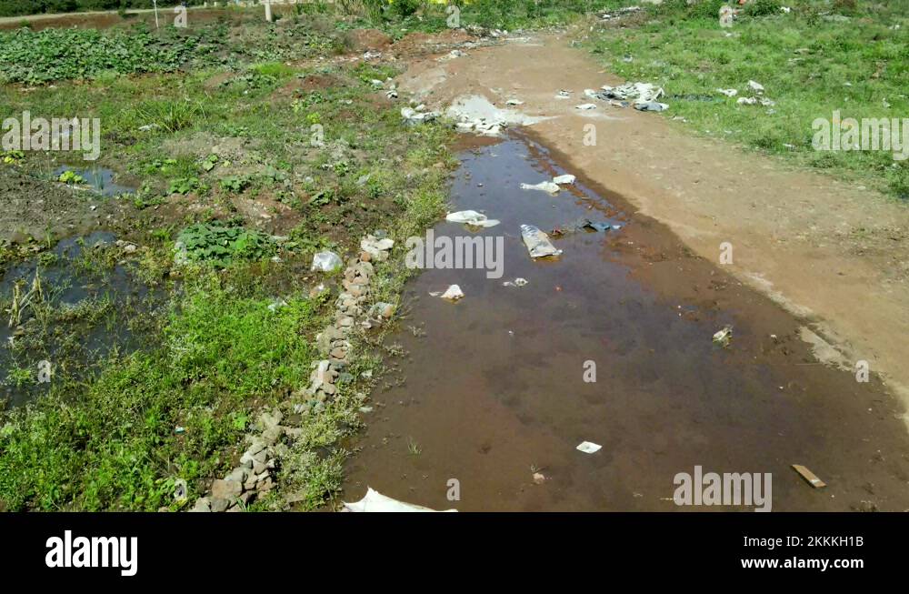 Steady forward low angle of dirty water pools with garbage and waste on Stock Video Footage Alamy