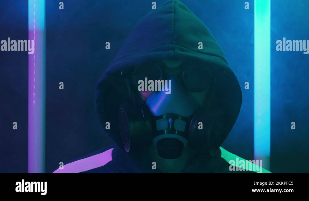Dangerous man in gas mask, glasses on flickering blue neon light