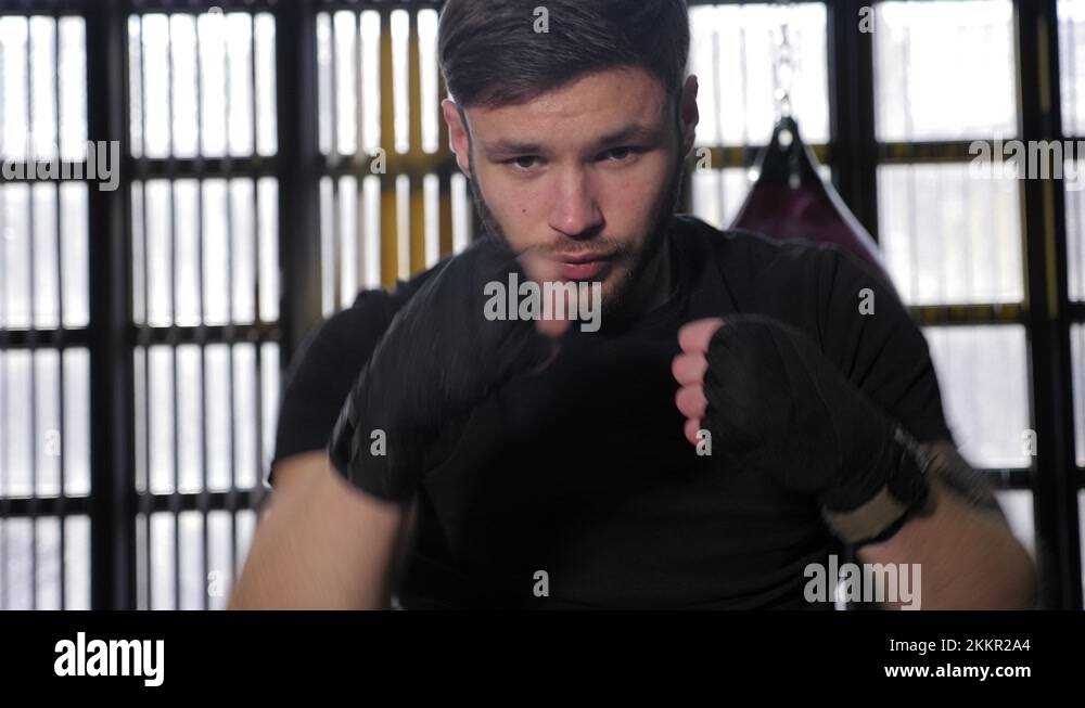 Young muscular man practicing punches in the boxing ring Stock Video