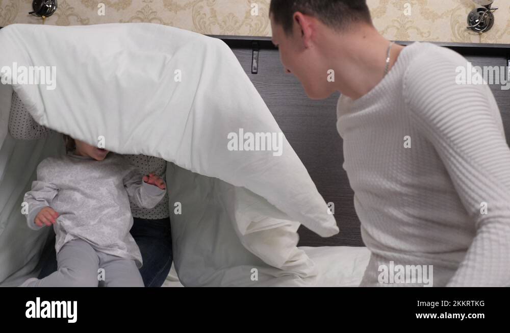 Happy family child, daughter mom dad play paddle together in room on ...