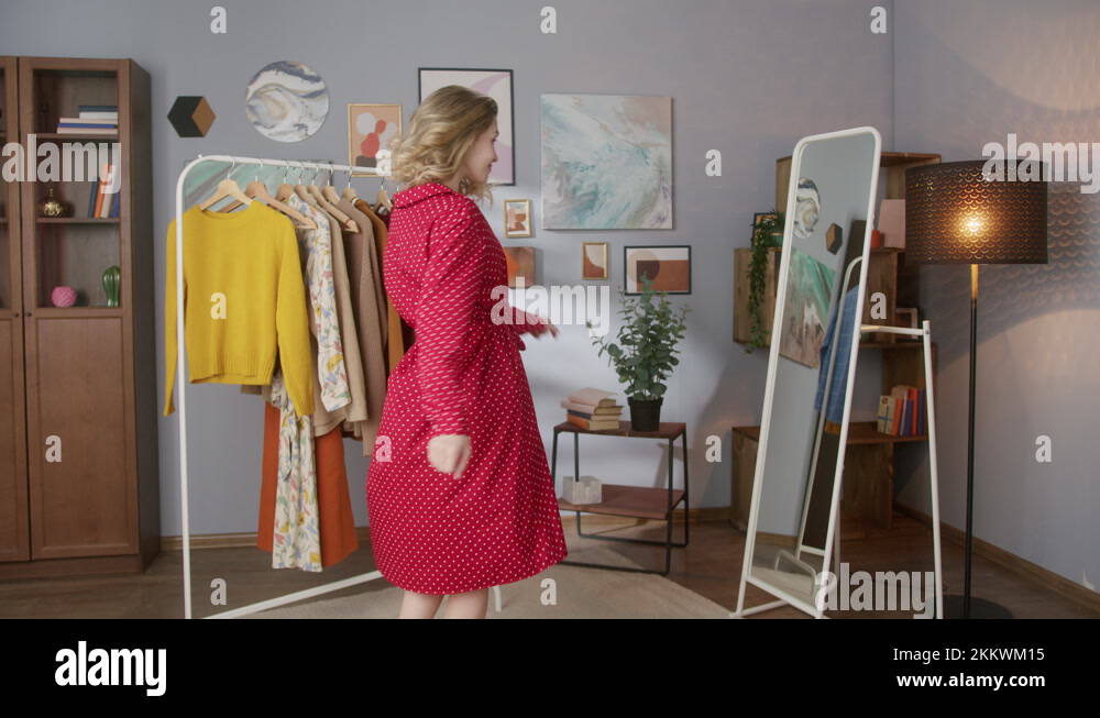 Woman near wardrobe with clothes choosing what to wear, shopping mall small Stock Video Footage