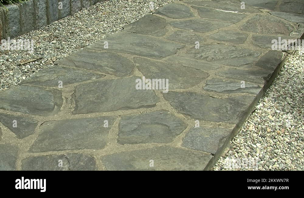 A formal style pathway of flagstones in a Japanese garden Stock Video