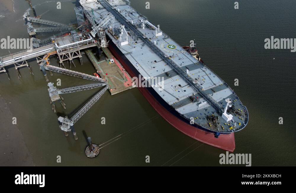 Crude oil tanker ship loading at refinery harbour terminal aerial