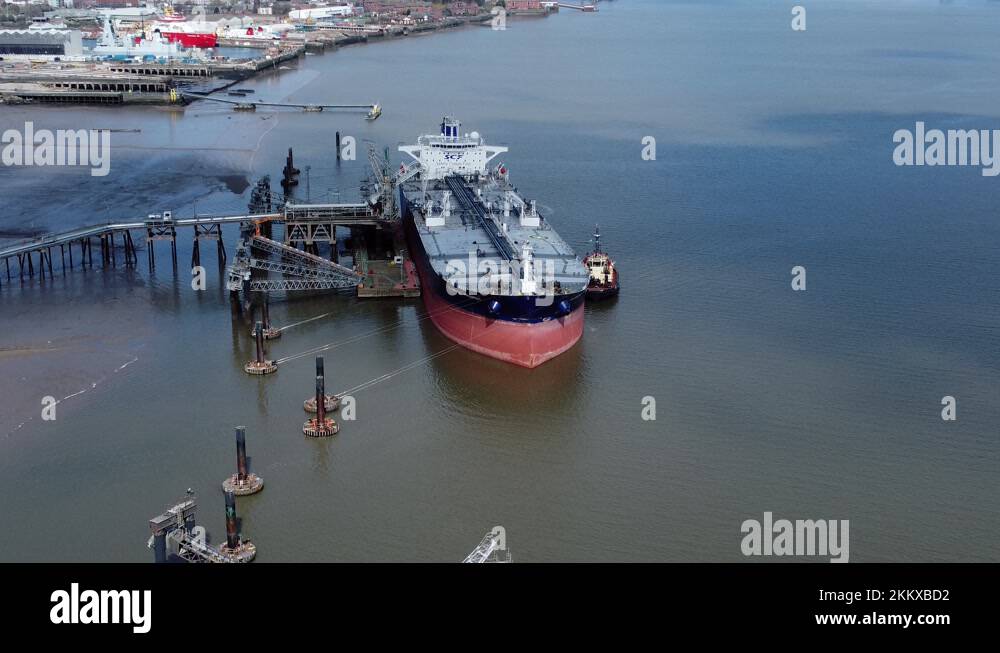 Crude oil tanker ship loading at refinery harbour terminal aerial