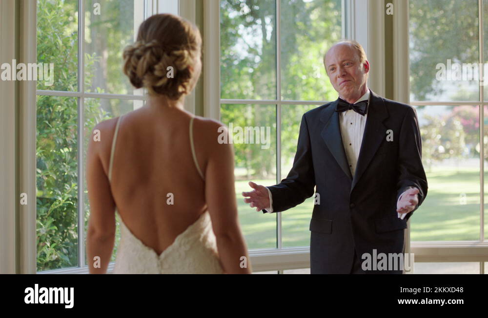 A father seeing his daughter in her wedding dress for the first time, hugging Stock Video